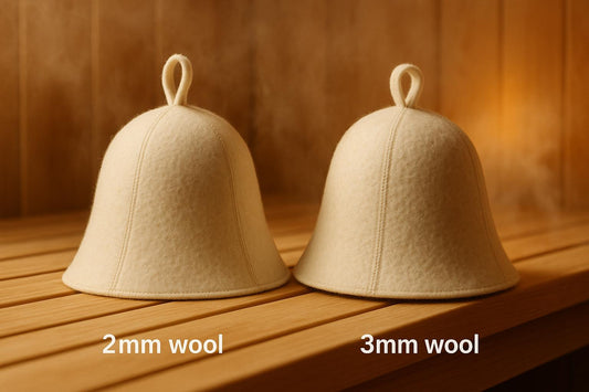 Two ivory wool felt sauna hats on a cedar bench showing thickness comparison — 2mm wool on the left, 3mm wool on the right