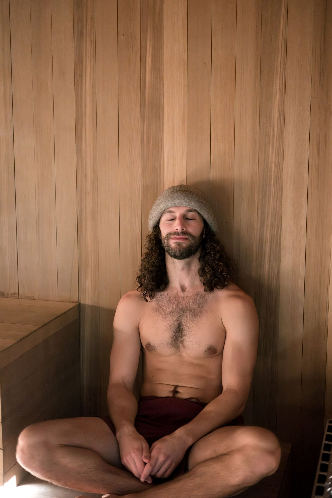 Schvitzin premium merino wool sauna hat worn in sauna, heat protection for longer sauna sessions